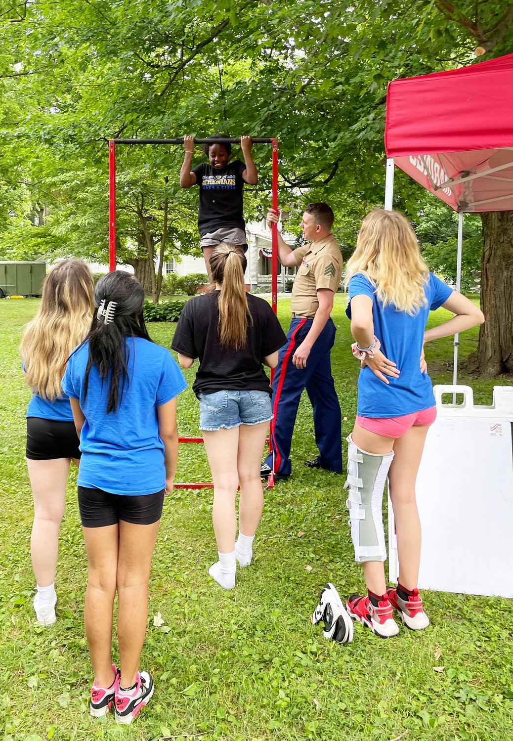 A Crawfordsville High School cheerleader participates in a pull-up challenge issued by members of the US Marine Corps.